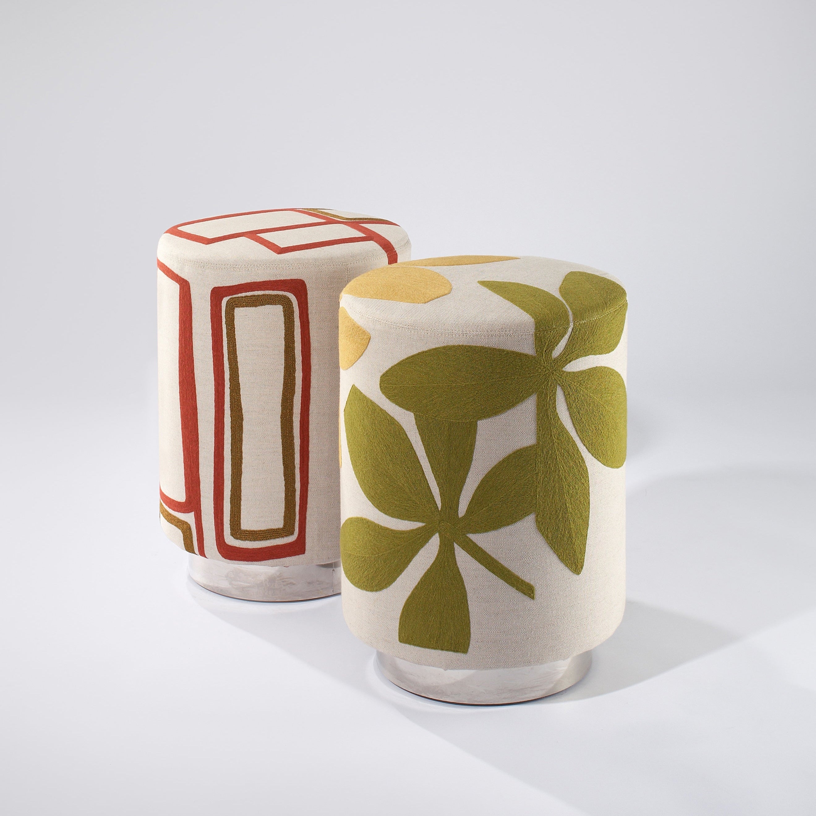 Two ceramic stools with geometric patterns on a white background